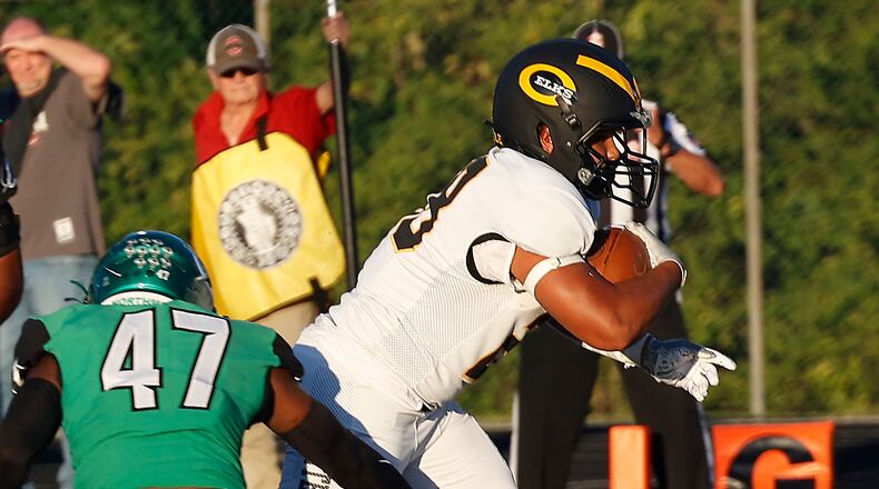 Centerville's Parker Johnson carries the ball into the end zone against Northmont last season. BILL LACKEY/STAFF