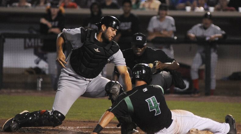 John Sansone of the Dragons beats the tag of Stevie Berman to score a go-ahead run. Dayton hosted Great Lakes in a Class A minor-league baseball doubleheader at Fifth Third Field on Tuesday, June 13, 2017. MARC PENDLETON / STAFF