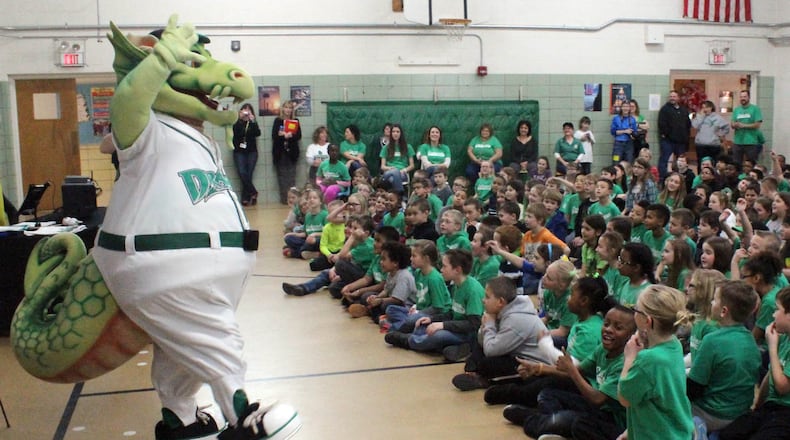 Dragons Baseball mascot Heater entertains students at Englewood Elementary School as part of an outreach to participate in the Dayton Dragons School Program. The incentive-based school fundraiser provides prizes to students and allows the schools to keep a portion of ticket sales to Dragons games. CHUCK HAMLIN / STAFF
