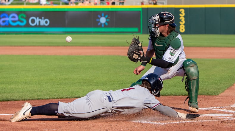 Dayton Dragons catcher Connor Burns waits for the throw as Lake County's Tommy Hawke scores the third run on a double in the fourth inning by Christian Knapczyk on Thursday, July 3 at Day Air Ballpark. JEFF GILBERT / CONTRIBUTED