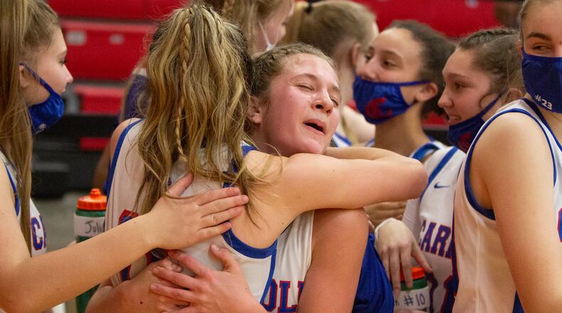 Carroll's Sarah Ochs (right) and Ava Lickliter hug as the Patriots celebrate their 57-48 victory over previously unbeaten Tippecanoe on Monday night at Tecumseh High School Jeff Gilbert/CONTRIBUTED