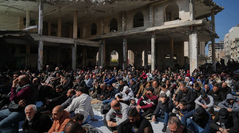 Muslim worshippers gather for Friday prayer during the holy fasting month of Ramadan at the Alkanz Mosque, which was damaged during the Israel–Hamas war, in Gaza City, Friday, Feb. 20, 2026. (AP Photo/Jehad Alshrafi)