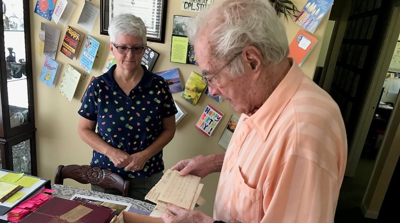 With daughter Beverly Rutan looking on, Walter Stitt looks at one of the 82 letters (the rest are in the hat box in front of him) he wrote during World War II to his mother who was living in West Virginia. Some of his letters were penned when he was in basic and advanced training at Camp Polk, Louisiana and the rest came as he served in Sherman tanks in France, Belgium and Germany. He was in some of the war’s deadliest battles: the Battle of Normandy and the Battle of the Bulge. Twice his tank commanders and others alongside him in tanks were killed by German shells. He received two Purple Hearts; the National Order of the Legion of Merit, the highest honor of France; and the Order of Saint George Medallion, the top award given to members of the Army's mounted force (tanks, cavalry) by the United States Armor Association of the United States Army. Tom Archdeacon/CONTRIBUTED