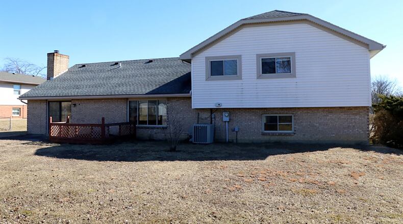 Patio doors open off the family room to a concrete patio and wooden deck.