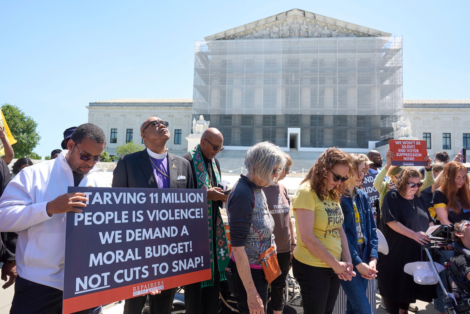 Activists with the Poor People's Campaign protest against spending reductions across Medicaid, food stamps and federal aid in President Donald Trump's spending and tax bill being worked on by Senate Republicans this week, outside the Supreme Court in Washington, Monday, June 2, 2025. (AP Photo/J. Scott Applewhite)