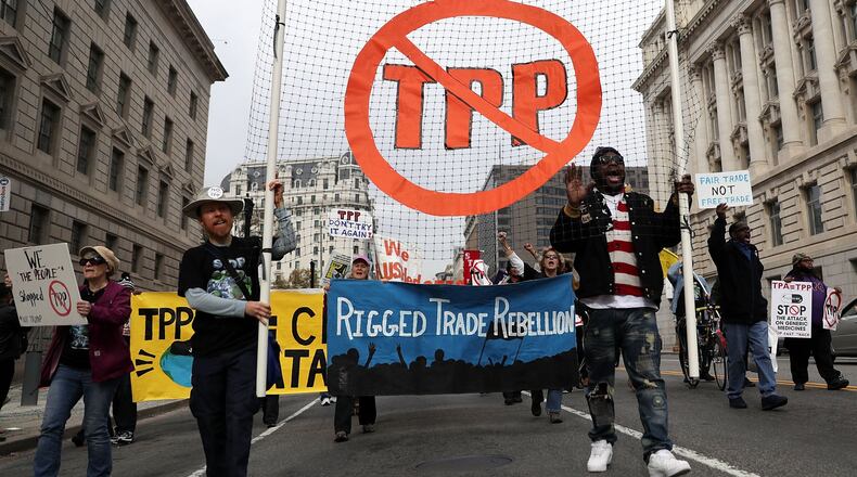 Activists shout slogans as they march during an anti-TPP protest Nov. 14, 2016 in Washington, D.C. Activists held a rally and a march “to protest the Trans-Pacific Partnership and urge President-elect Donald Trump and members of Congress to reject the trade deal.” ALEX WONG/GETTY IMAGES