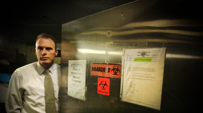 Montgomery County Coroner Kent Harshbarger at the door of the morgue, 361 West Third St. Dayton. JIM WITMER / STAFF