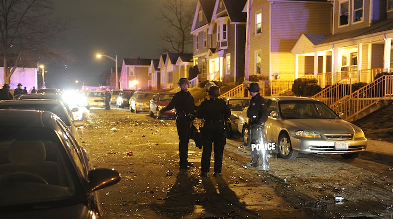 Police wear riot gear and keep watch during a disturbance near the University of Dayton campus that prompted UD police to call in backup from many other jurisdictions.