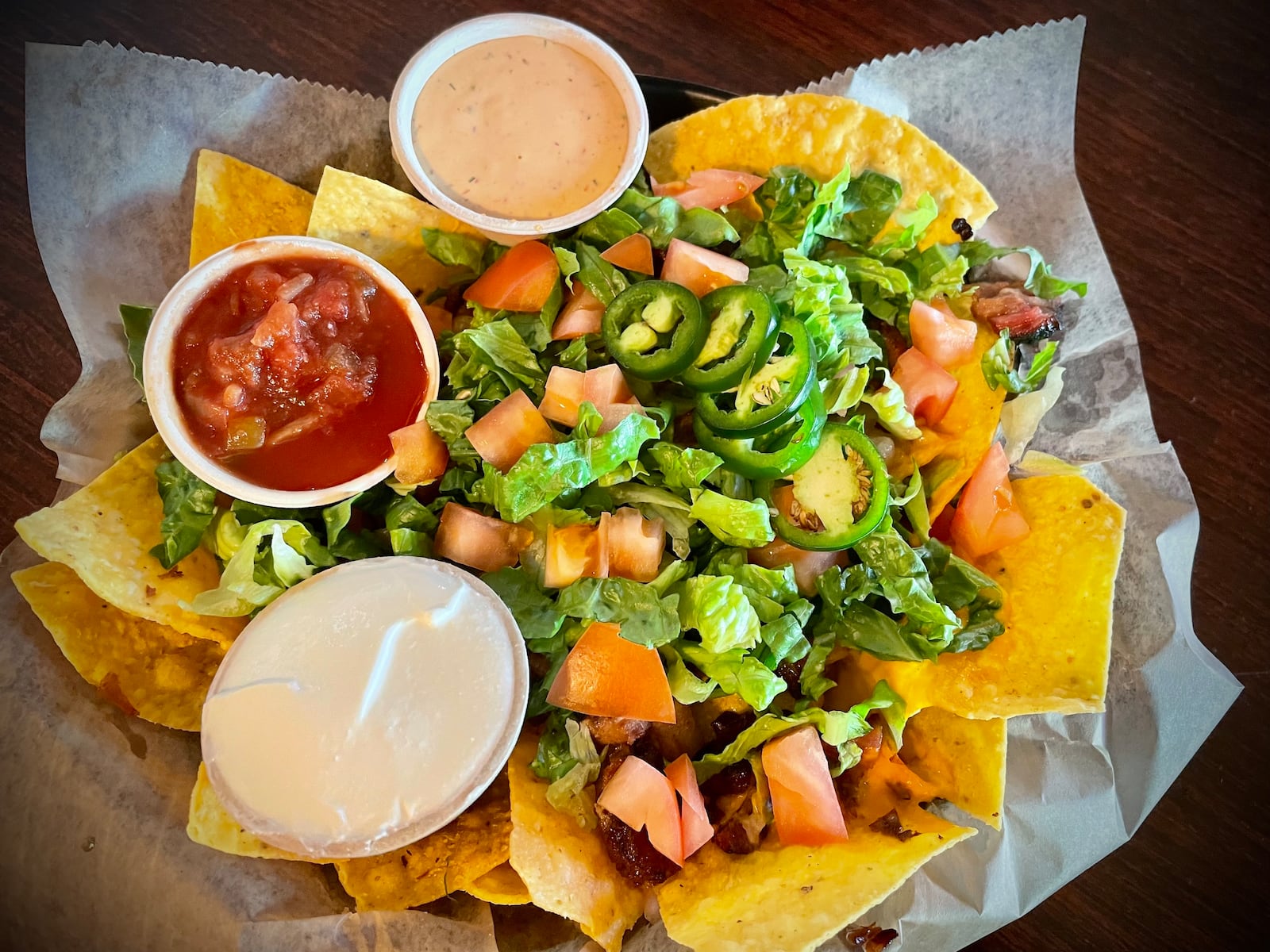Fifth Street Brewpub is located at 1600 E. Fifth St. in Dayton's St. Anne's Hill neighborhood. Pictured are the Fifth Street Nachos featuring BBQ brisket. NATALIE JONES/STAFF