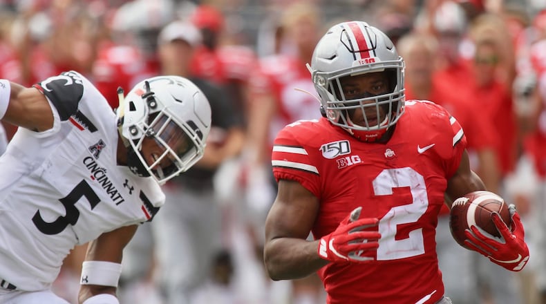 Ohio State’s J.K. Dobbins runs for a touchdown as Cincinnati’s Darrick Forrest, left, watches on Saturday, Sept. 7, 2019, at Ohio Stadium in Columbus. David Jablonski/Staff
