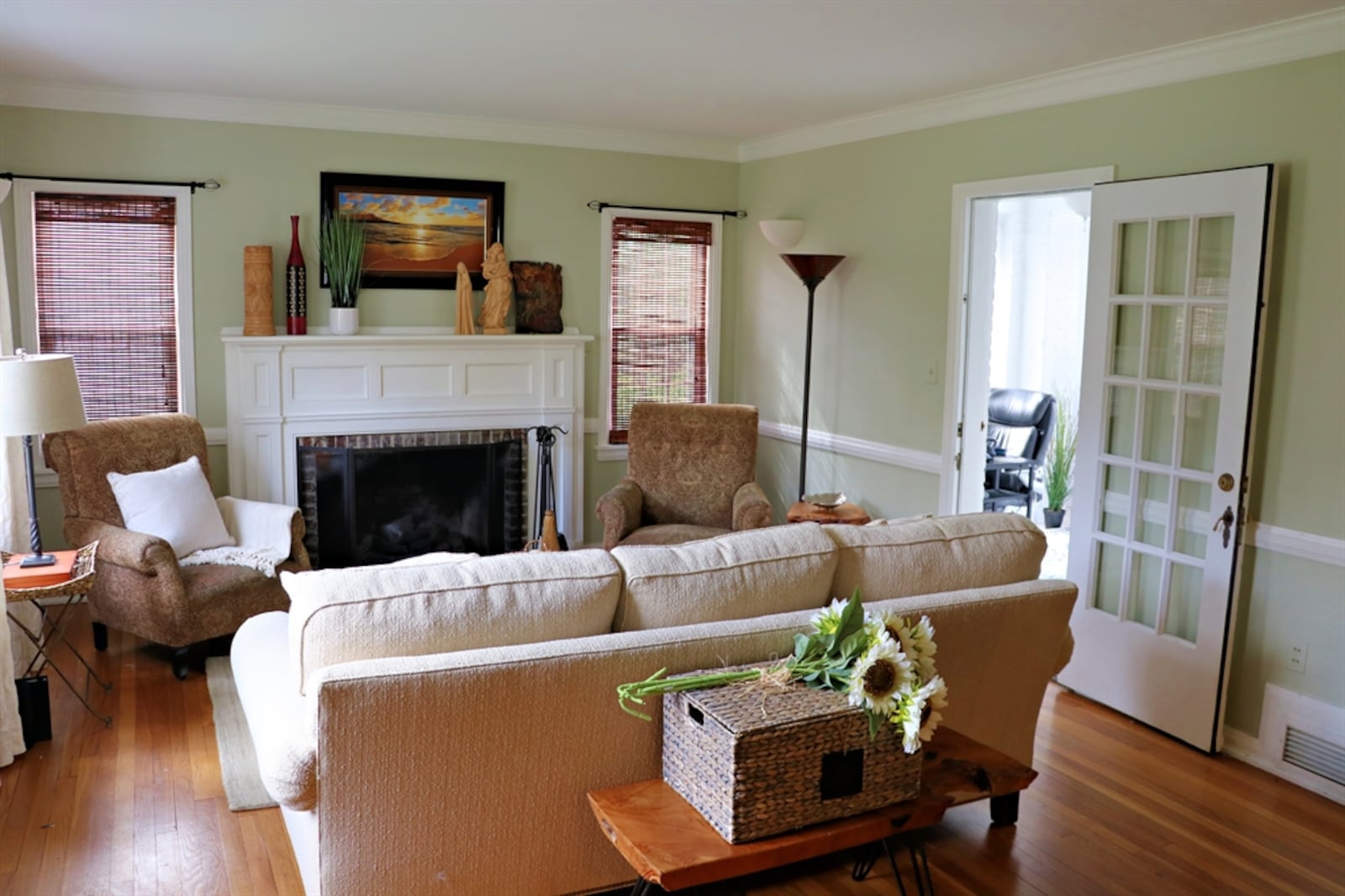 The formal living room features a decorative fireplace as the centerpiece.