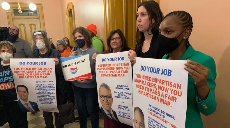 Demonstrators call on the Ohio Redistricting Commission to follow the guidance of the mapmakers they hired Monday night. JORDAN LAIRD / STAFF