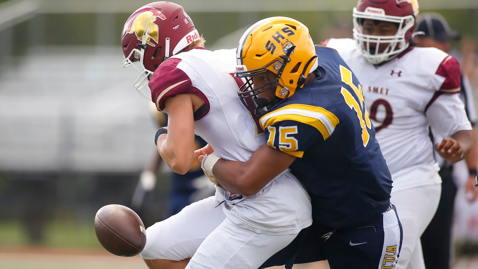 Springfield High School defensive end Jackson Heims rips the ball away from a St. Louis De Smet Jesuit player during their Week 2 game last season at Brebeuf Jesuit Preparatory School in Indianapolis. Heims was one of several area players to pick up new scholarship offers last week. Michael Cooper/CONTRIBUTED