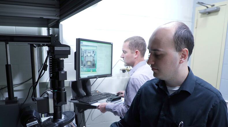 Researchers Dr. Drake Austin with UES Inc. and Dr. Nicholas Glavin with the Air Force Research Laboratory work together in the laser writing of electronics laboratory in this 2020 photo. U.S. AIR FORCE PHOTO/SPENCER DEER