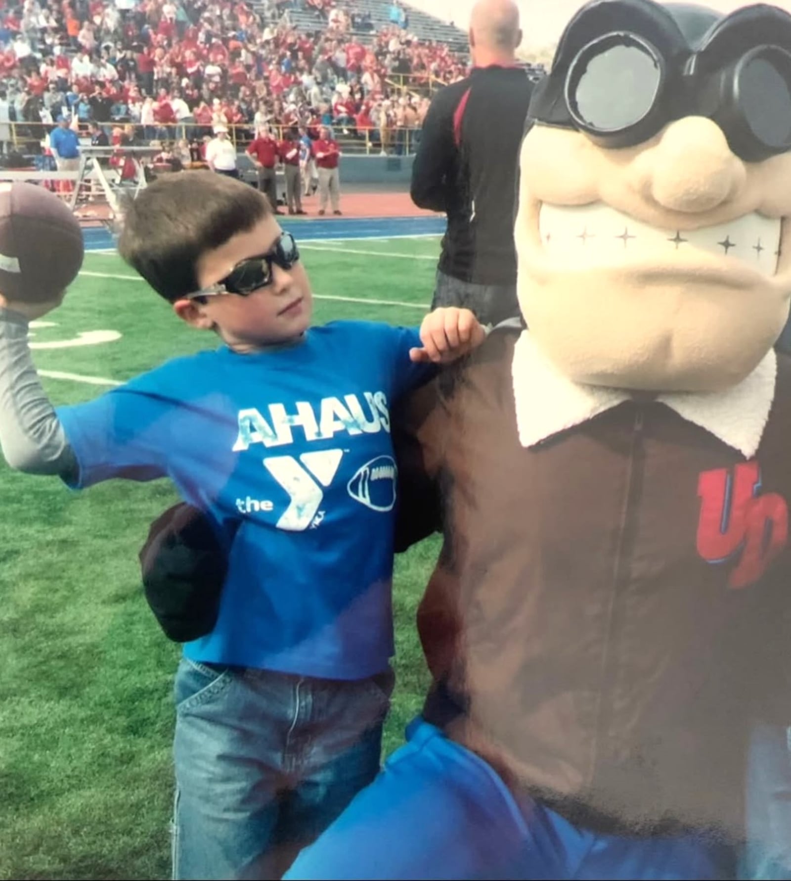 From the time he was a little boy, Drew VanVleet, seen here with UD mascot Rudy Flyer, was a regular at Dayton Flyers football and basketball games. They had basketball season tickets and at football games they sometimes stood on the Welcome Stadium sidelines and at halftime threw a football back and forth in the endzone. Drew’s dad was a standout linebacker for the Flyers and his mom Kelli (Buer) played softball for UD. CONTRIBUTED PHOTO
