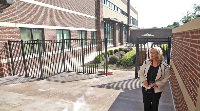 Kelly Rigger, CEO of Springfield Mental Health Services, looks over a new outdoor space that's been constructed with the new addition Thursday, August 18, 2022. BILL LACKEY/STAFF