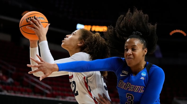 Dayton forward Brynn Shoup-Hill drives to the basket ahead of DePaul guard Deja Church, right, during the second half of a First Four game in the NCAA women's college basketball tournament, Wednesday, March 16, 2022, in Ames, Iowa. Dayton won 88-57. (AP Photo/Charlie Neibergall)