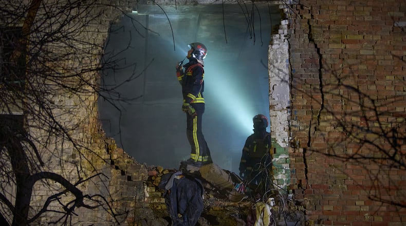 Rescuers search for victims after a drone hit a residential building during Russia's night missile and drone attack in Kyiv, Ukraine, Saturday. Nov. 29, 2025. (AP Photo/Efrem Lukatsky)