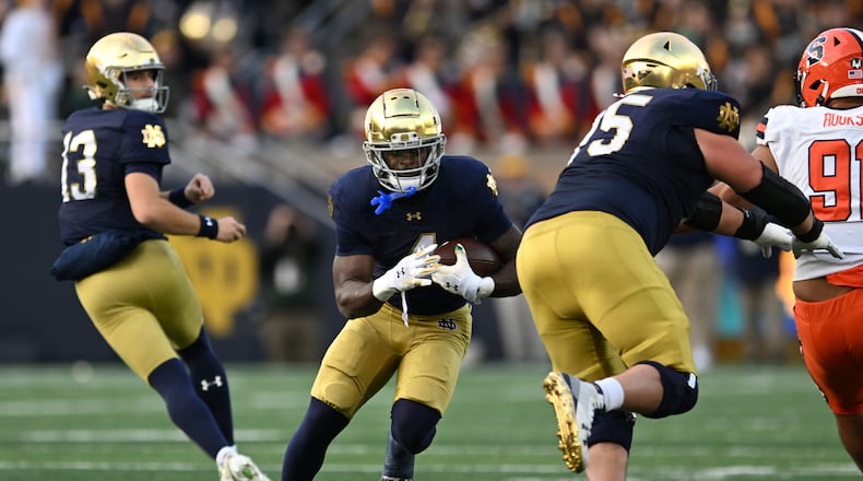 Notre Dame running back Jeremiyah Love (4) rushes during the first quarter of an NCAA football game against Syracuse, Saturday, Nov. 22, 2025, in South Bend, Ind. (AP Photo/Paul Beaty)