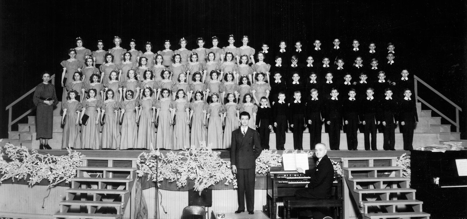 The Inland Childrens Chorus, formed in 1936, was the only corporation-sponsored childrens choir in the United States. It was the brainchild of Wallace Whitacre, founding general manager of the Inland Manufacturing Division of General Motors Corporation. At center is chorus director Richard Westbrock and at the organ is Urban Deger. 
Photo: InlandChorus.com