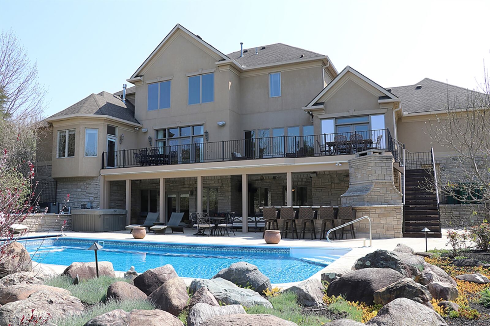 Outdoor space features a stone foundation for a gas grill, pizza oven with countertops and drawers. Paver stones surround the 18-by-36-foot swimming pool, which has a heater and electric cover. The patio extends past the pool into a circular courtyard sitting nook complete with wood-burning chimney fireplace. CONTRIBUTED PHOTO