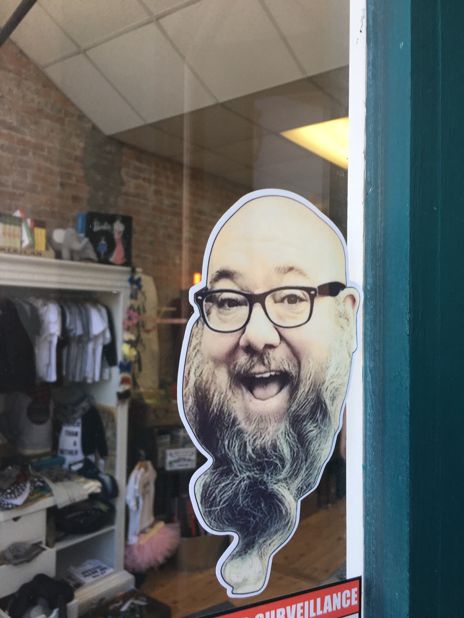 Stickers are being sold in the Oregon District to support Brad Darrell. The long-time manager of Glenn Scott Tattoo  recently suffered a stroke. (Photo by Amelia Robinson)