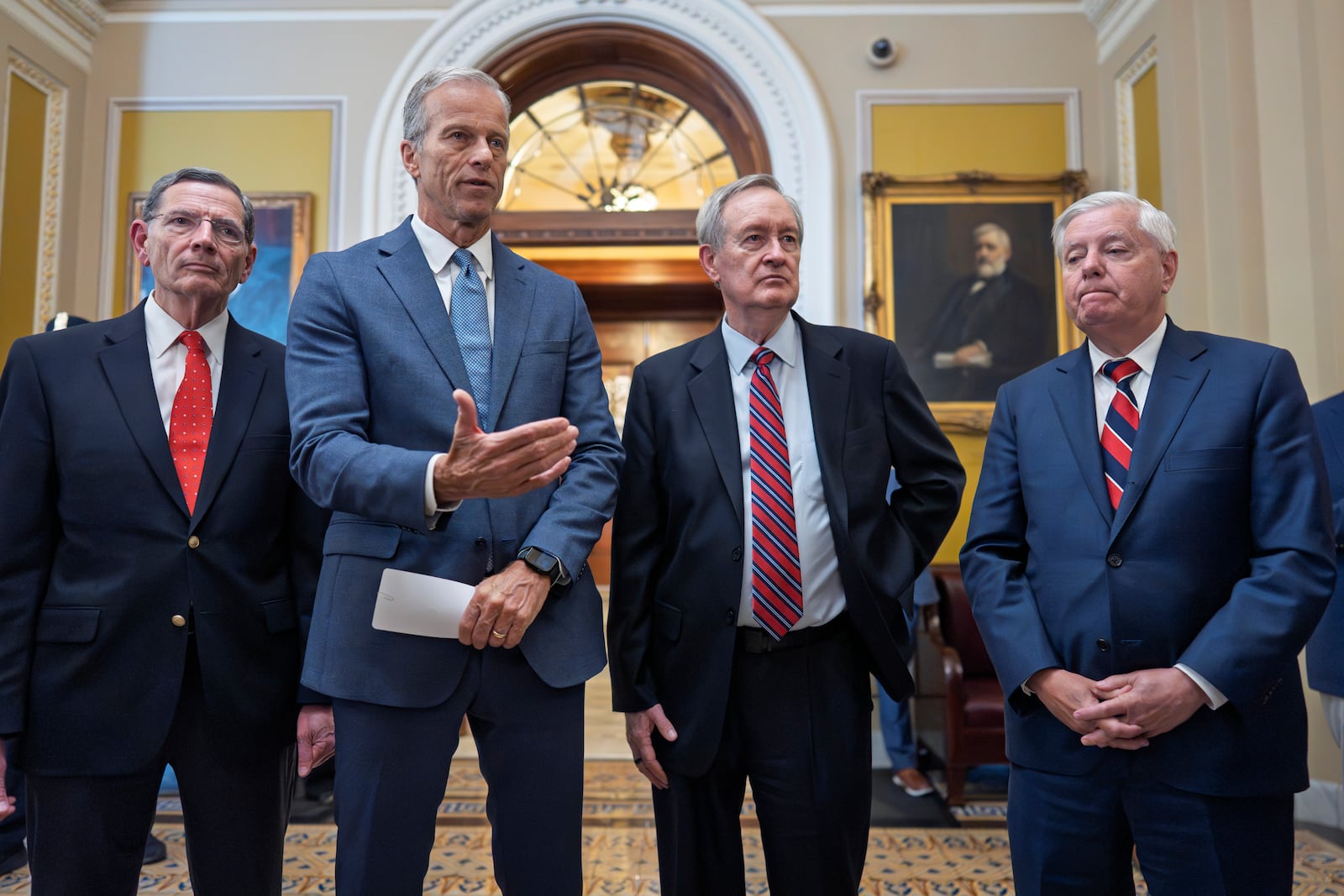 Senate Majority Leader John Thune, R-S.D., center, joined from left by, Sen. John Barrasso, R-Wyo., the GOP whip, Finance Committee Chairman Mike Crapo, R-Idaho, and Budget Committee Chairman Lindsey Graham, R-S.C., speaks to reporters after passage of the budget reconciliation package of President Donald Trump's signature bill of big tax breaks and spending cuts, at the Capitol in Washington, Tuesday, July 1, 2025. (AP Photo/J. Scott Applewhite)