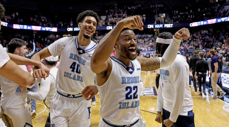 Rhode Island guard RJ Johnson (22) and forward Keeyan Itejere (40) celebrate their win over Saint Louis in an NCAA college basketball game, Tuesday, Feb. 17, 2026, in South Kingstown, R.I. (AP Photo/Mark Stockwell)