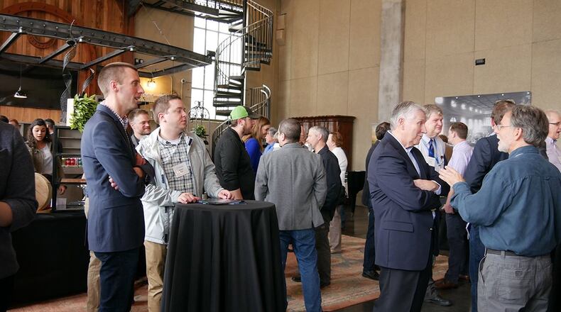 Guests network with small business vendors at the T3 Demo Day pitch event April 5 at the Steam Plant, a downtown Dayton event space. (U.S. Air Force photo/Emily Martin)