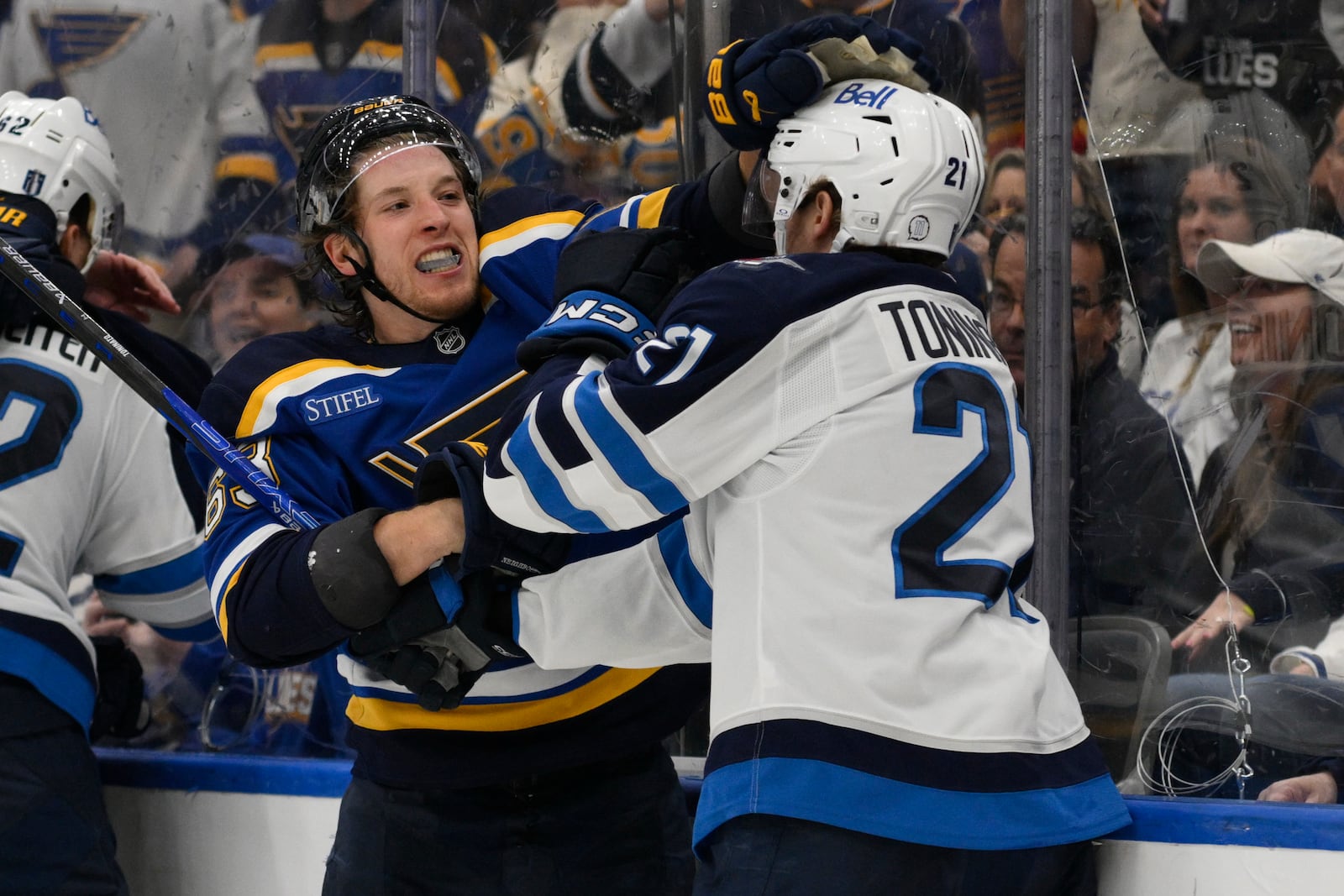 St. Louis Blues left wing Jake Neighbours, second from right, gets physical with Winnipeg Jets center Dominic Toninato, right, during the third period in Game 6 of an NHL hockey first-round playoff series Friday, May 2, 2025, in St. Louis. (AP Photo/Jeff Le)