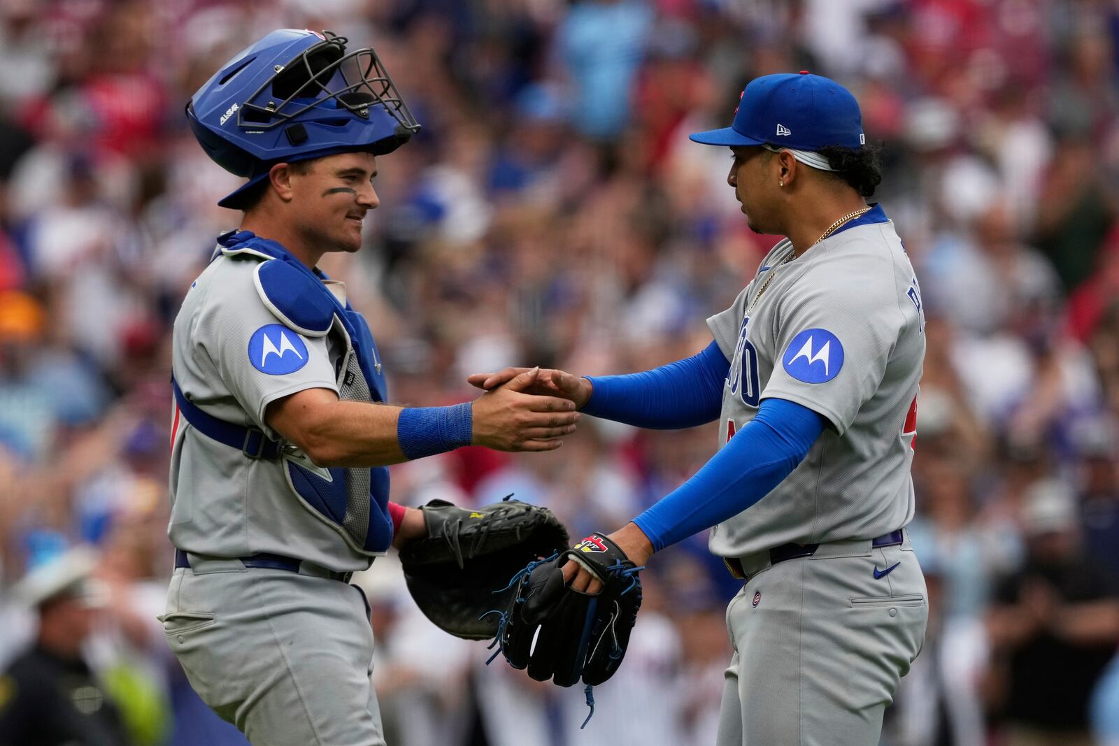 Chicago Cubs' catcher Reese McGuire, left, and pitcher Daniel Palencia, right, celebrate after winning a baseball game against the Cincinnati Reds, Sunday, May 25, 2025, in Cincinnati. (AP Photo/Carolyn Kaster)