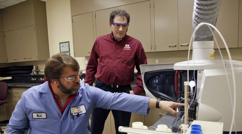 Lab Analyst Rick Pennington, left, and Lab Services Manager Jim Davis, Montgomery County Environmental Services, monitor a lead testing machine.  TY GREENLEES / STAFF