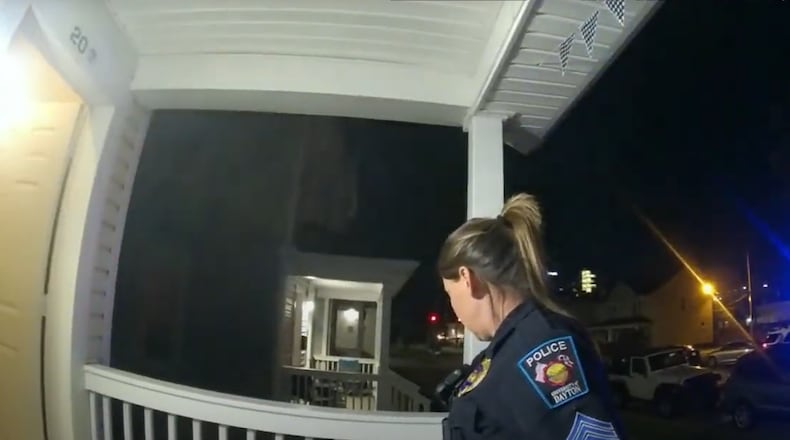 Officers on body cameras wait outside of a University of Dayton rowhouse for a student they believed was screaming obscenities at them while they were working. Courtesy of UD