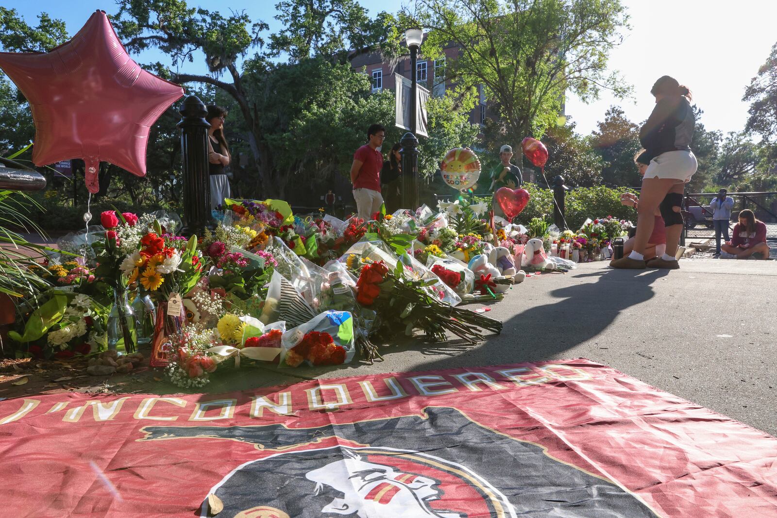 Students gather on a stretch of sidewalk near the center of the Florida State campus in sight of the Student Union building, Tallahassee, Fla., Friday, April 18, 2025. (AP Photo/Gary McCullough)