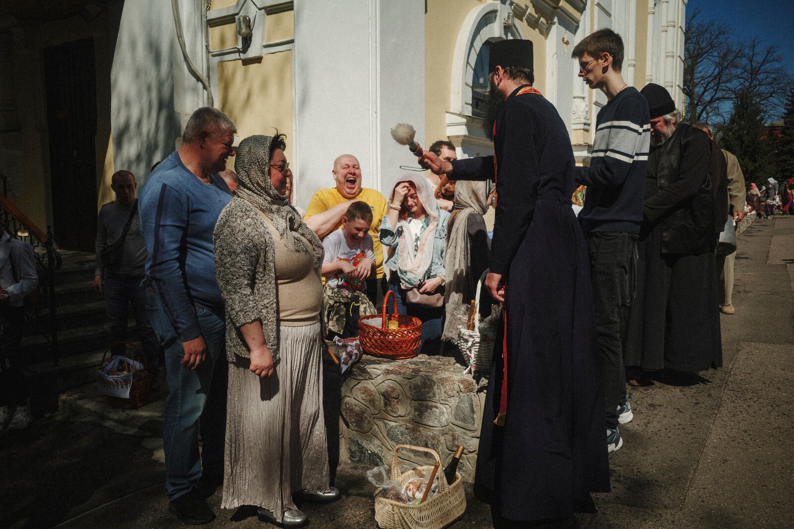 A priest blesses Easter baskets during the celebration of Orthodox Easter at Cross Lower Church of the Ukrainian Orthodox Church in Kharkiv, Ukraine, on Sunday, April 20, 2025. (AP Photo/George Ivanchenko)