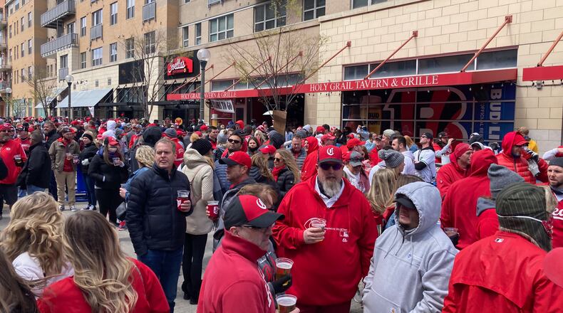 Fans mill around The Banks on Opening Day before a game between the Cincinnati Reds and St. Louis Cardinals on Thursday, April 1, 2021, at Great American Ball Park in Cincinnati. DAVID JABLONSKI/STAFF