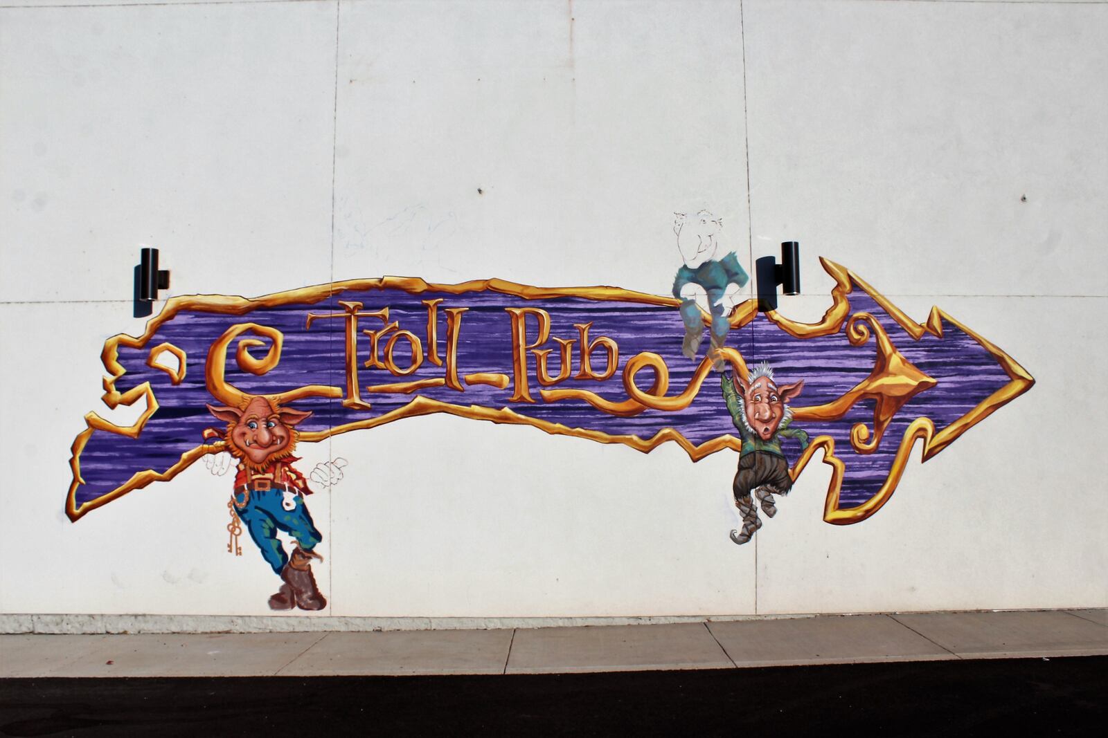 A trio of trolls are being painted on the Wheelhouse building directing people to the the future location of Troll Pub in Dayton's historic Oregon District. Photo by Amelia Robinson