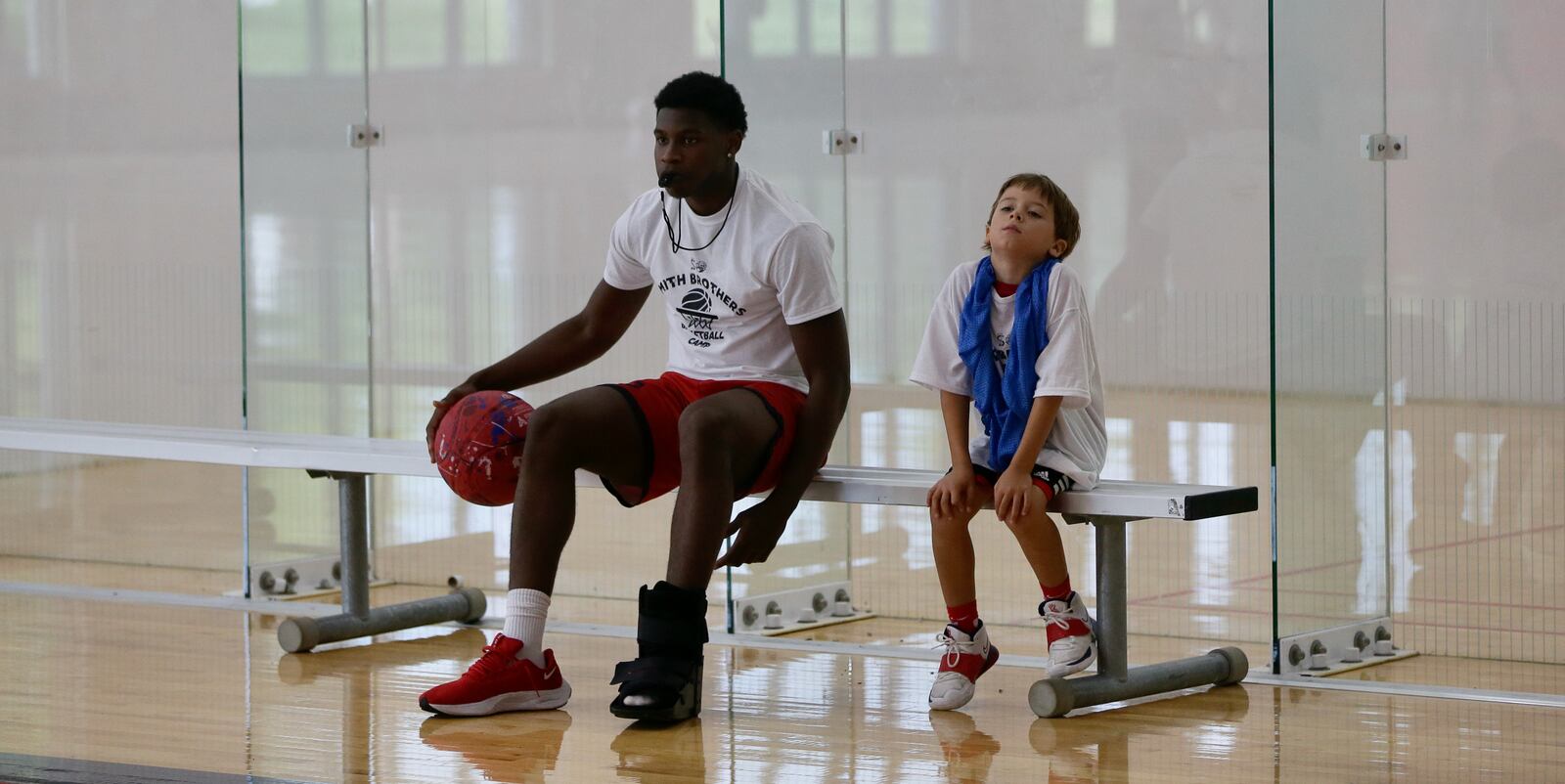 Malachi Smith sits next to a kid at the Smith Camp on Saturday, July 16, 2023, at the UD Rec Plex. David Jablonski/Staff