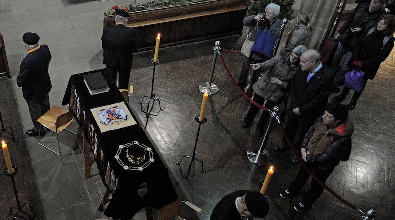 FILE - In this Monday, March 23, 2015 file photo, members of the public view the coffin of Richard III as it lies in repose inside Leicester Cathedral, Leicester, England. (AP Photo/Rui Vieira, File)