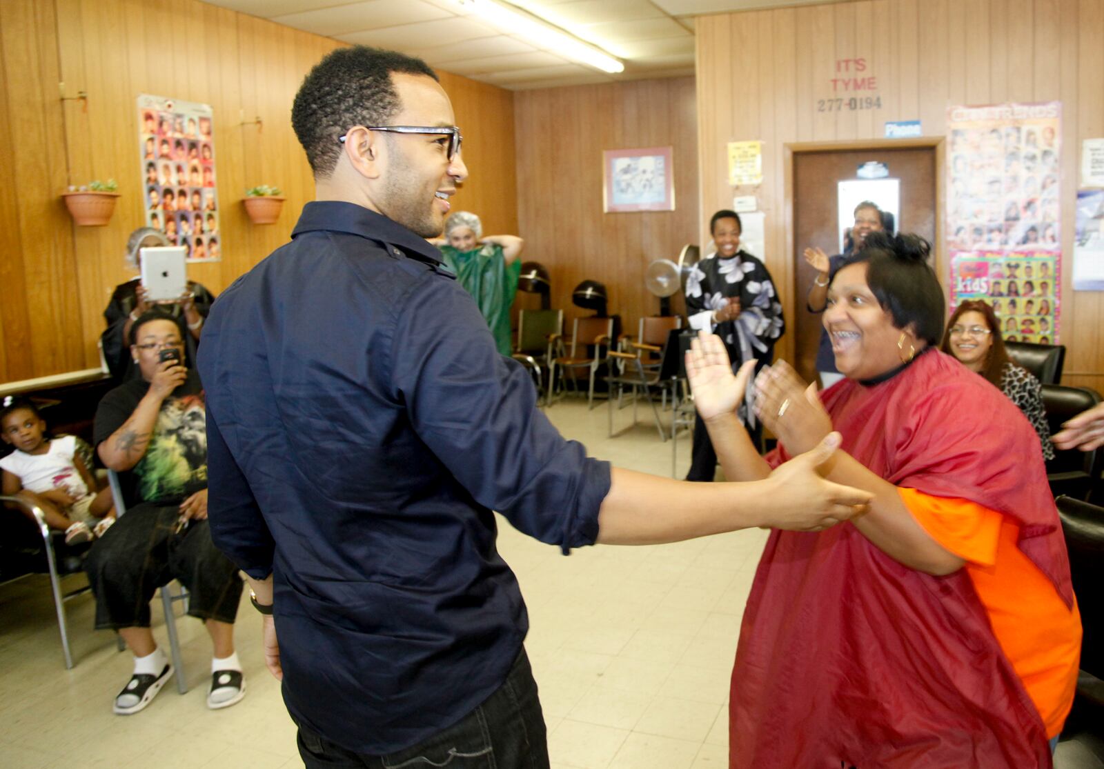 Grammy award winning singer John Legend made a stop at It's Tyme  Beauty Shop in Dayton in 2012 to encourage people to register to vote and to support President Barack Obama's re-election.Legend greets shop patron Nicole Wilks-Foster of Dayton. LISA POWELL / STAFF