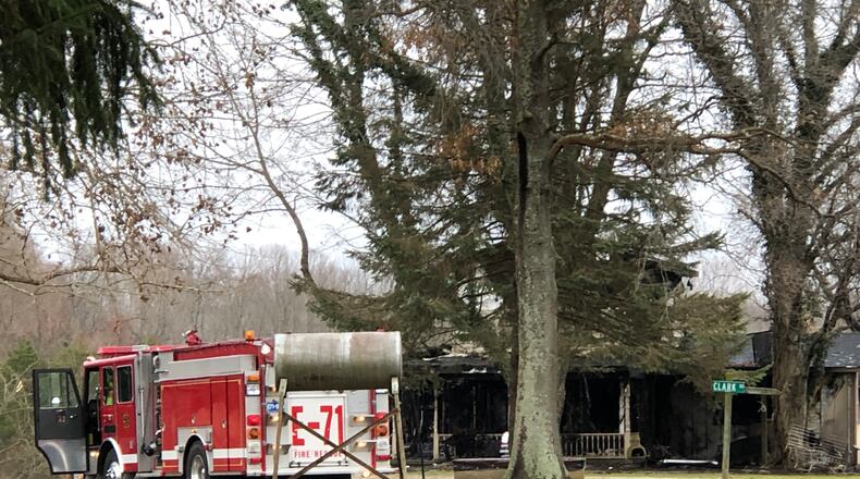 A two-story home in the 2300 bloack of Phillips Road outside Lebanon was badly damaged by a fire reported at 4:30 a.m. Tuesday, according to fire officials. LAWRENCE BUDD / STAFF