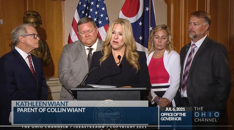 Kathleen Wiant speaks about her son Collin, a college student who died as a result of hazing, during a news conference Tuesday before Ohio Gov. Mike DeWine, left, signed an anti-hazing law. Also pictured are Collin's father Wade Wiant and at right, Shari and Cory Foltz, the parents of Stone Foltz, who also died in a hazing incident. THE OHIO CHANNEL
