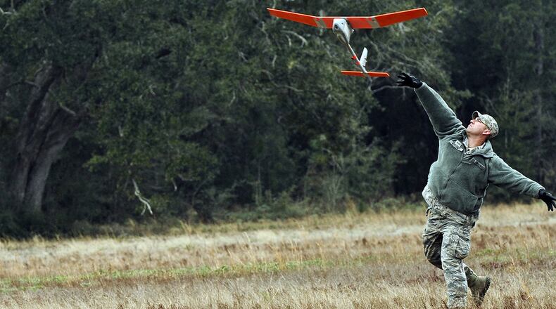 Senior Airman Andrew Goffeney, 1st Special Operations Security Forces Squadron combat arms journeyman, launches a RQ-11B Raven at Choctaw Field, Fla., March 4, 2014. Goffeney practiced launching the small unmanned aerial system, which requires a specific technique for takeoff. (U.S. Air Force photo/Senior Airman Michelle Patten)