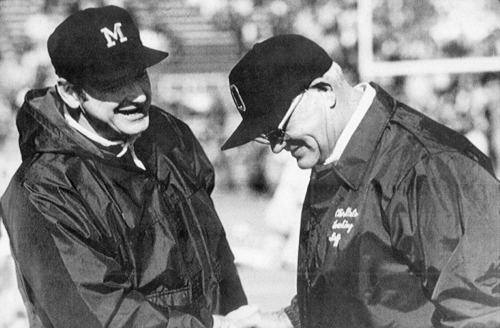 Michigan football coach Bo Schembechler, left, meets with Ohio State coach Woody Hayes in this undated photo, location unknown. (AP Photo)