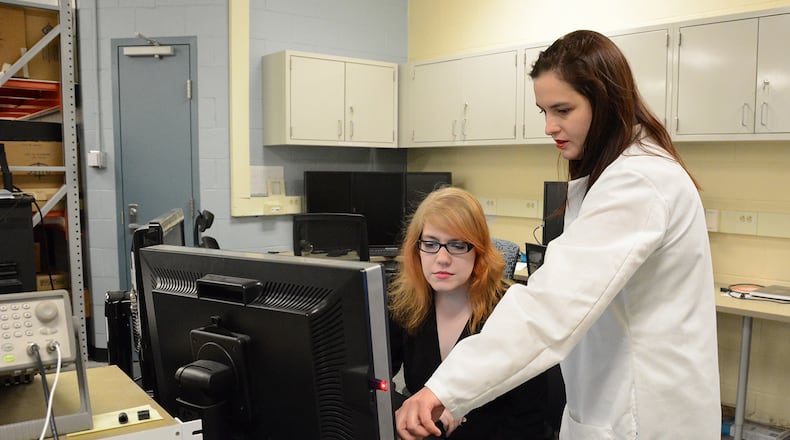 Air Force Research Laboratory Materials and Manufacturing Directorate researchers Megan Imel, left, and Dr. Amanda Criner discuss laboratory test data. Air Force Women in Science and Engineering, or AFWiSE, is a resource group that gives female scientists and engineers a forum to gather and share new ideas, while promoting the growth and professional development of women within AFRL. (U.S. Air Force Photo/Lori Hughes)