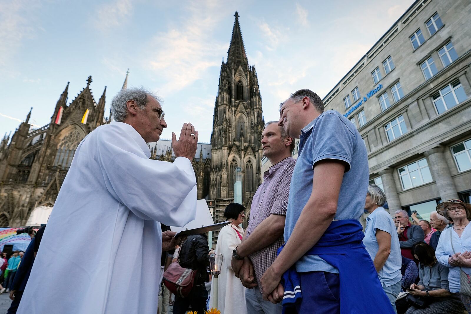 FILE - Same-sex couples take part in a public blessing ceremony in front of the Cologne Cathedral in Cologne, Germany, on Sept. 20, 2023. (AP Photo/Martin Meissner, File)