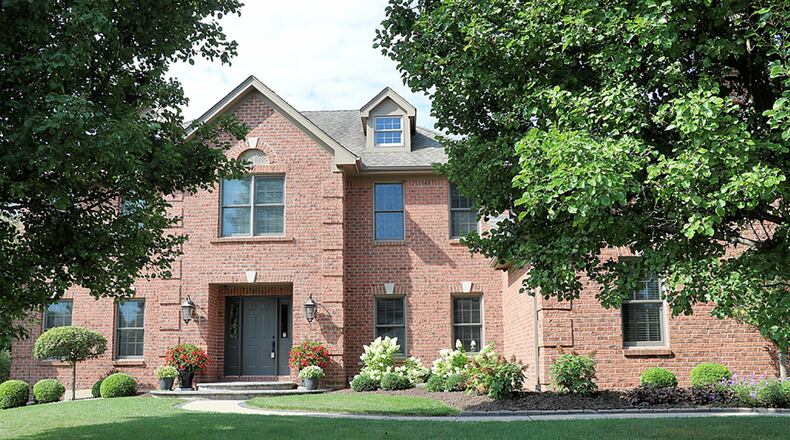 The brick 2-story has about 6,010 sq. ft. of living space within the three levels. The house sits on a cul-de-sac, near-acre lot with a mature tree-lined back yard and a side-entry, 3-car garage. CONTRIBUTED PHOTO BY KATHY TYLER