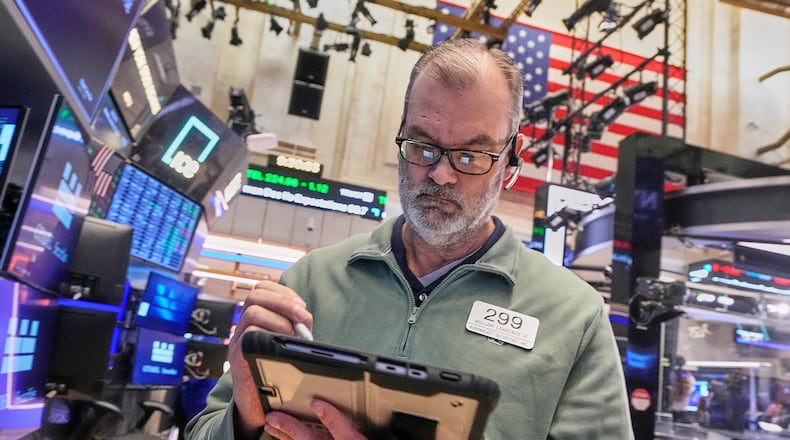 Trader William Lawrence works on the floor of the New York Stock Exchange, Monday, Jan. 26, 2026. (AP Photo/Richard Drew)