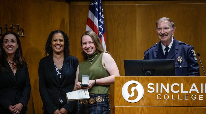 Dayton Daily News reporter London Bishop received special recognition for reporting on and participating in the Sinclair College Criminal Justice Training Academy on Wednesday evening June 12, 2024, at the graduation ceremony held at Sinclair College. JIM NOELKER/STAFF