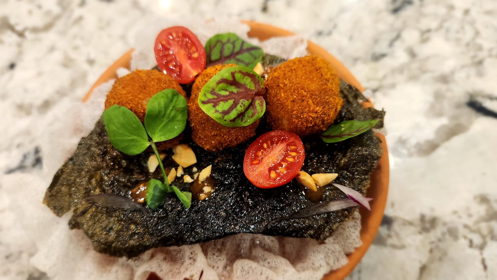 Vivian Elebiyo-Okojie, the founder of Bread of Hope, is sharing the stories of African flavors and culture through the inaugural Nomad’s Table on Saturday, May 24 in Dayton.  Pictured is Suya Fish Balls served on rice paper seaweed (CONTRIBUTED).